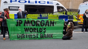 Extinction Rebellion Protesters Rally Against Greenwashing Outside JP Morgan Building in Glasgow