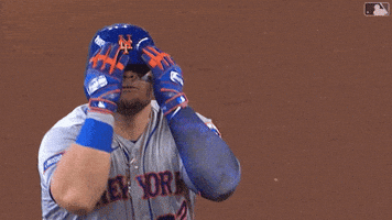 Sports gif. Daniel Vogelbach of the New York Mets pulls his hands down over his face with a confident and intimidating expression like he's miming tears. 