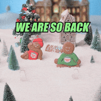 Sponsored gif. Two hands place two lounging gingerbread men into a snowy scene where two additional cookies are already relaxing. Text: "WE ARE SO BACK"