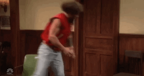 SNL gif. Jason Momoa wears a sports letterman with no arms. He picks up a wooden chair and bashes it against the wall in a fury of rage.