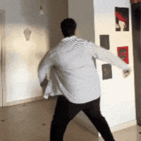 A looping GIF of a man in a blue shirt dancing energetically, arms flailing and legs kicking in a spontaneous, joyful motion.
