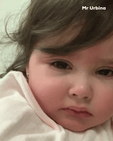 Video gif. Crying sad baby is in a close up shot as tears fall down their cheeks.