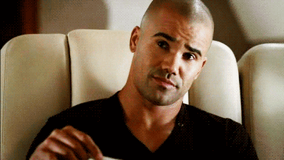 TV gif. The face of Shemar Moore as Morgan in Criminal Minds cracks into a warm smile and laugh.