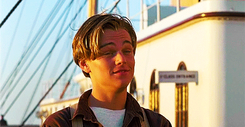 Movie gif. Leonardo DiCaprio as Jack Dawson from Titanic stands sunkissed on the ship and presses his lips together in reluctant acceptance.