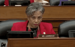 Politics gif. Brenda Lawrence wearily leans her hand against the side of her forehead at the Capitol Hill hearing of Michael Cohen.