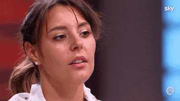 Reality TV gif. Lia on Masterchef Italy has a tired look in her eyes as she huffs out a huge sigh. 