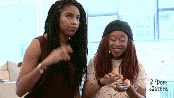TV gif. Jessica Williams and Phoebe Robinson on 2 Dope Queens. Jessica makes the OK symbol with her hand, then mimes shooting a gun in the air, while Phoebe smiles and nods, tapping on her cellphone.