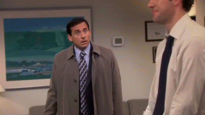 The Office gif. Steve Carell as Michael looks determined as he rushes toward John Krasinski as Jim and tackles him in a hug.