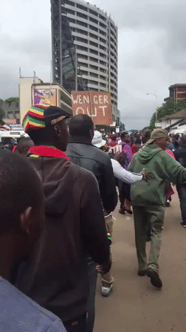 'Wenger Out' Sign Spotted Amid Protests Against Robert Mugabe