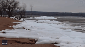 Sheets of Ice Pile Onto Shoreline of Frozen Lake Superior