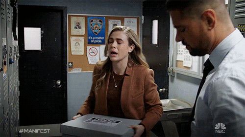 TV gif. In a locker room, Melissa Roxburgh as Michaela is holding a stack of white boxes goes to leave and is roughly stopped by a man, who grabs her arm and starts to say something to her.