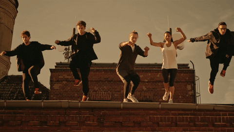 Video gif. Five people jump off a ledge and it's in slow motion for the height of the jump and the rest is played normally.