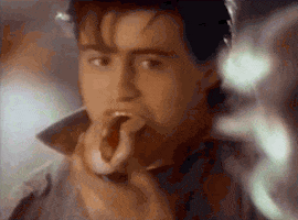 Ad gif. A vintage ad for Heinz with Matt LeBlanc. He takes a bite of a hot dog and sends us a cute wink. Text, "Heinz. Good things come to those who wait."