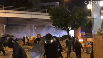 Protesters' Fire Bombs Met With Police Water Cannon in Hong Kong Clash