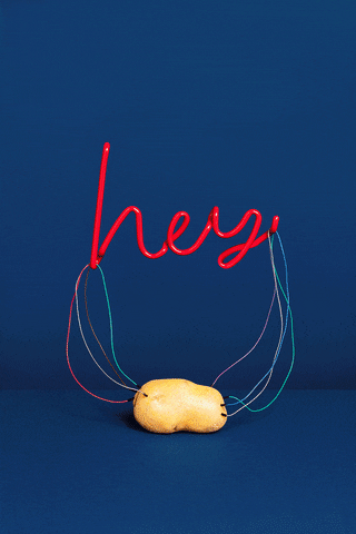 Text gif. Neon lettering wired to a potato lights up and glows pink, and reads "Hey."