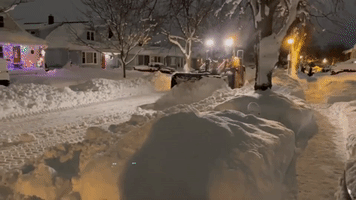 Plow Shifts Large Amounts of Snow After Blizzard