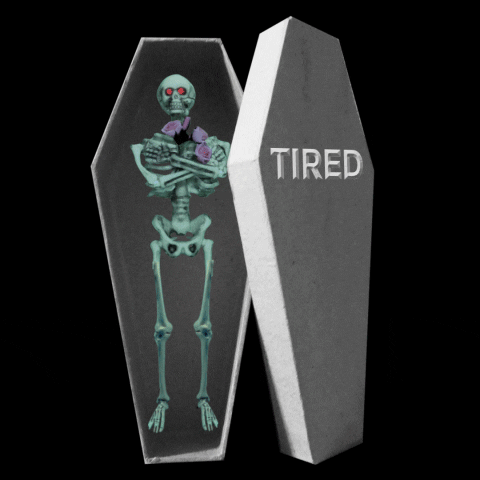 Digital art gif. Sleeping skeleton rests inside a coffin labeled “tired” with its arms folded as three Z’s appear over its head, then his eyes glow red.