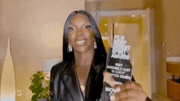 Celebrity gif. Michaela Coel moves her Indie Spirit Award towards us and says, “Boom!”