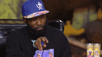 TV gif. Desus Nice points at someone and then points back to his lips like he’s applying chapstick. 