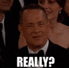 Celebrity gif. Tom Hanks staring at us with squinted eyes, in disbelief at what's being told to him. He says, "Really?" 