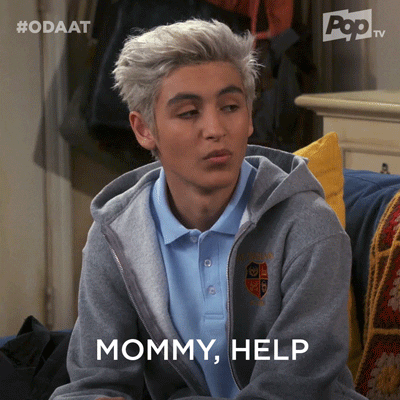 TV gif. Marcel Ruiz as Alex Alvarez on One Day At A Time sits looking at his mother. He has an unamused look on his face when he says, “Mommy, help,” and gives her a small smile begrudgingly.
