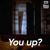 Sponsored gif. Bedroom door slowly opens to reveal someone standing on the other side under a white sheet with aviator shades on, pretending to be a ghost. In the upper right corner is the AMC Fear Fest logo. Text reads, “You up?”