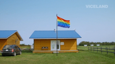 Lgbt Rainbow Flag GIF by GAYCATION with Ellen Page and Ian Daniel