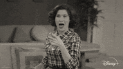 TV gif. Kathryn Hahn as Agatha Harkness on WandaVision holds a martini glass in her hands and gives a big smile and thumbs up.