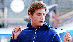 Movie gif. Emilio Estevez as Andrew in The Breakfast Club looks bored as he plays with the drawstring of his hoodie, pulling it one way and the other and turning his head to look at it. 