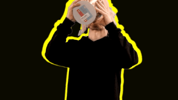 Celebrity gif. Louis Vecchio from the and New Politics dumps an entire bucket of popcorn into his mouth as it pours all over him.