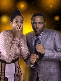 Celebrity gif. Tracee Ellis Ross and Anthony Anderson look at us, grimacing like they’re watching a disaster happen in front of them. Yellow glowing orbs move around in the background.