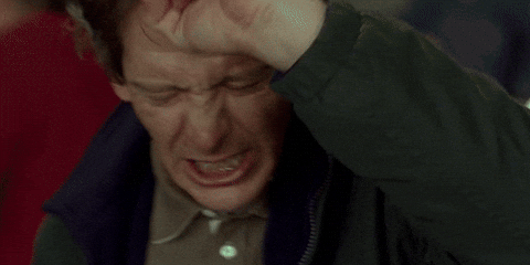 Movie gif. Ben Mendelsohn as Gerry in Mississippi Grind shakes his fisted hand over his head, grimacing in frustration.