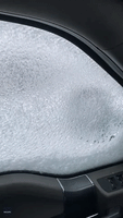 Sheet of Ice Freezes Over Car Window Amid Winter Storm Warning in Ontario