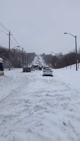 Vehicles Stuck as Winter Storm Dumps Snow on Toronto