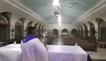 Priest Holds Mass as Typhoon Rai Hits the Philippines