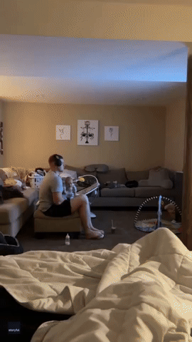 Father Tries to Feed Newborn While Using His Feet to Play Video Game