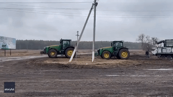 Ukrainian Farmer Tows Russian Military Tank Using Tractors