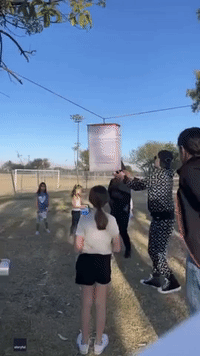 Children Duck for Cover as Piñata Fires Candy