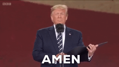 Political gif. Donald Trump stands at a microphone reading from a black folder with a flat expression. Text, "Amen."