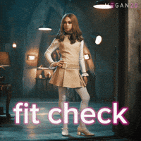 Sponsored gif. The haunted doll Megan strikes a pose with one hand on her hip and the other placed at her side. She wears a short, beige dress, white tights, and white heeled shoes. Text in front of her reads, “Fit check.”