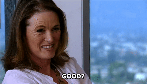 Celebrity gif. Lisa Love nods and smiles quizzically. Text, "Good?"