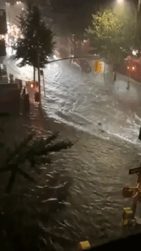 New York Streets Flooded After State of Emergency Declared Due To Hurricane Henri