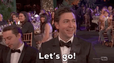 Celebrity gif. Nicholas Braun, seated at the SAG awards, points out in excitement agreeing "let's go!"