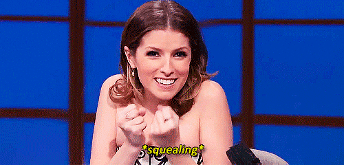 Celebrity gif. Anna Kendrick leans forward with a huge smile, clenching her fists tight with excitement. Text, "squealing."