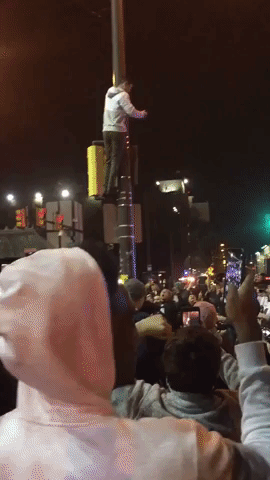 Man Scales Lamp Post During Celebration of Philadelphia Eagles Victory