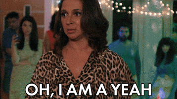 Movie gif. At a party, Maya Rudolph as Brinda in "Sisters" looks intense, bobbing her head emphatically as she says "Oh, I am a yeeeeah," which appears as text.