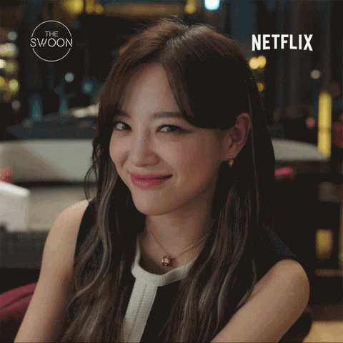 TV gif. Kim Se Jeong as Shin Ha Ri in Business Proposal. She smiles widely and looks into the camera cutely, giving us a wink as the camera slowly zooms in on her face.