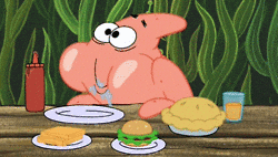 SpongeBob gif. Patrick sits at a table with plates of food in front of him. His cheeks are stuffed with food and his mouth moves in a circle as he chews. Drool dribbles from his mouth and he looks overjoyed.