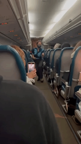 Flight Attendant Calms Delayed Passengers