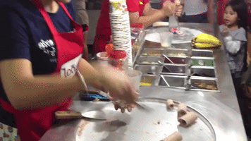 Street vendor shows off instant ice-cream rolls